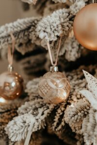 gold baubles on white christmas tree